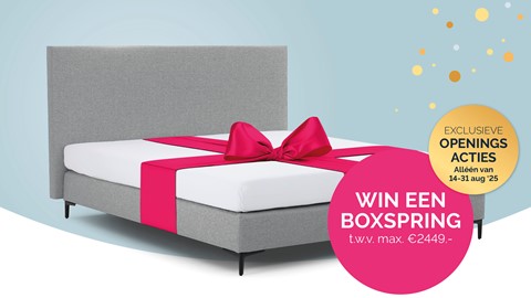 een bed met een roze strik