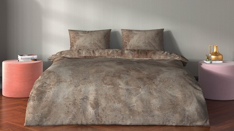 een bed met kussens en een sprei