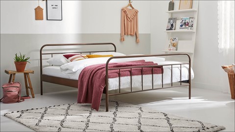 een bed met een roze deken