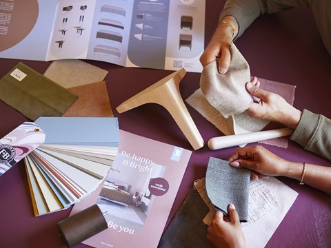 een groep mensen die aan een tafel werken