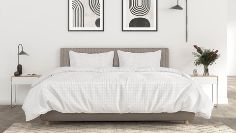 een bed met witte lakens en kussens
