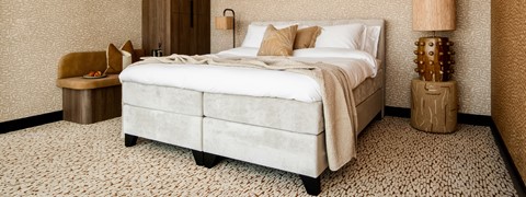 een bed met kussens en een lamp