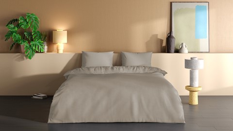 een bed met kussens en een foto aan de muur