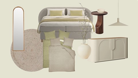 Een bed met kussens en een vaas bloemen